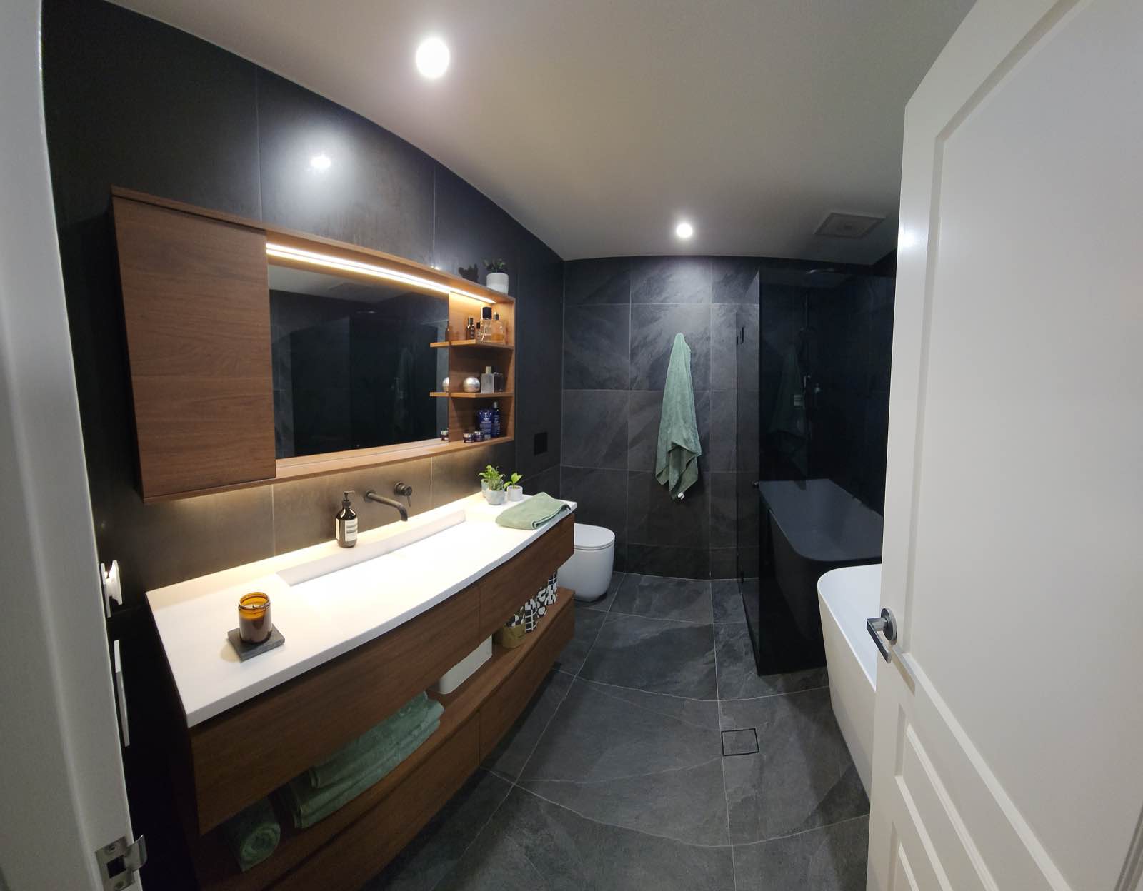 Ensuite now: freestanding bath, full-height large-format stone-look tile and frameless screen