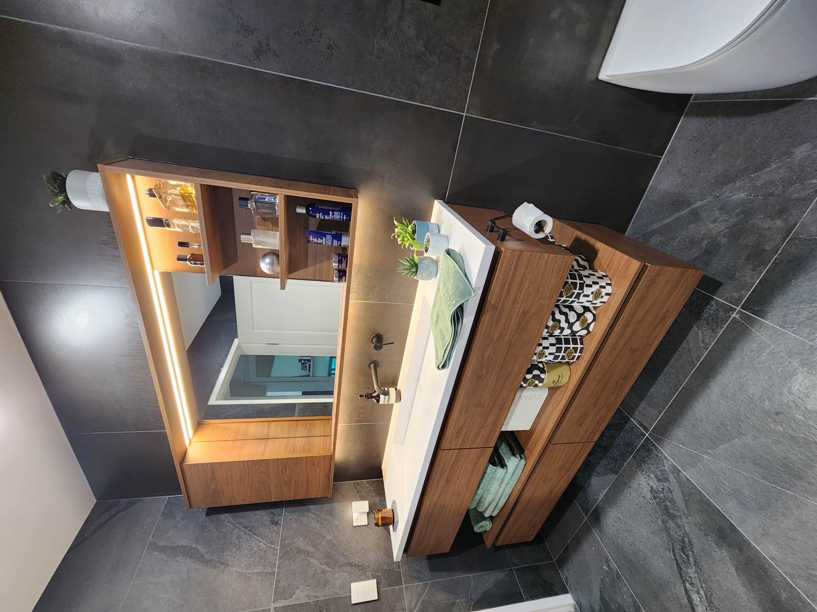 Ensuite now: timber floating vanity with integrated trough basin, backlit mirror cabinet and open shelving