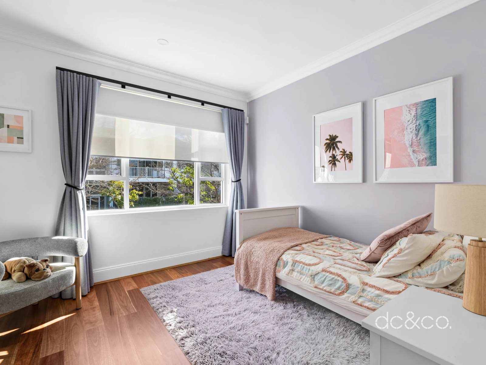 The third bedroom set up as a child's room, with a single bed and rug