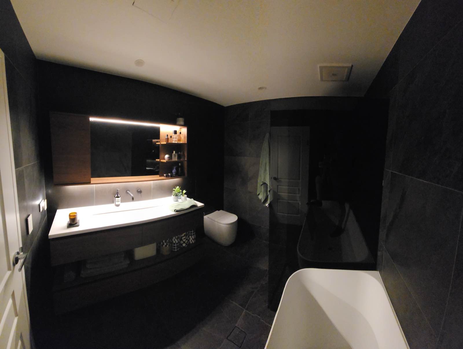 The ensuite in its low lighting mode, with the mirror strip and shelf lighting on