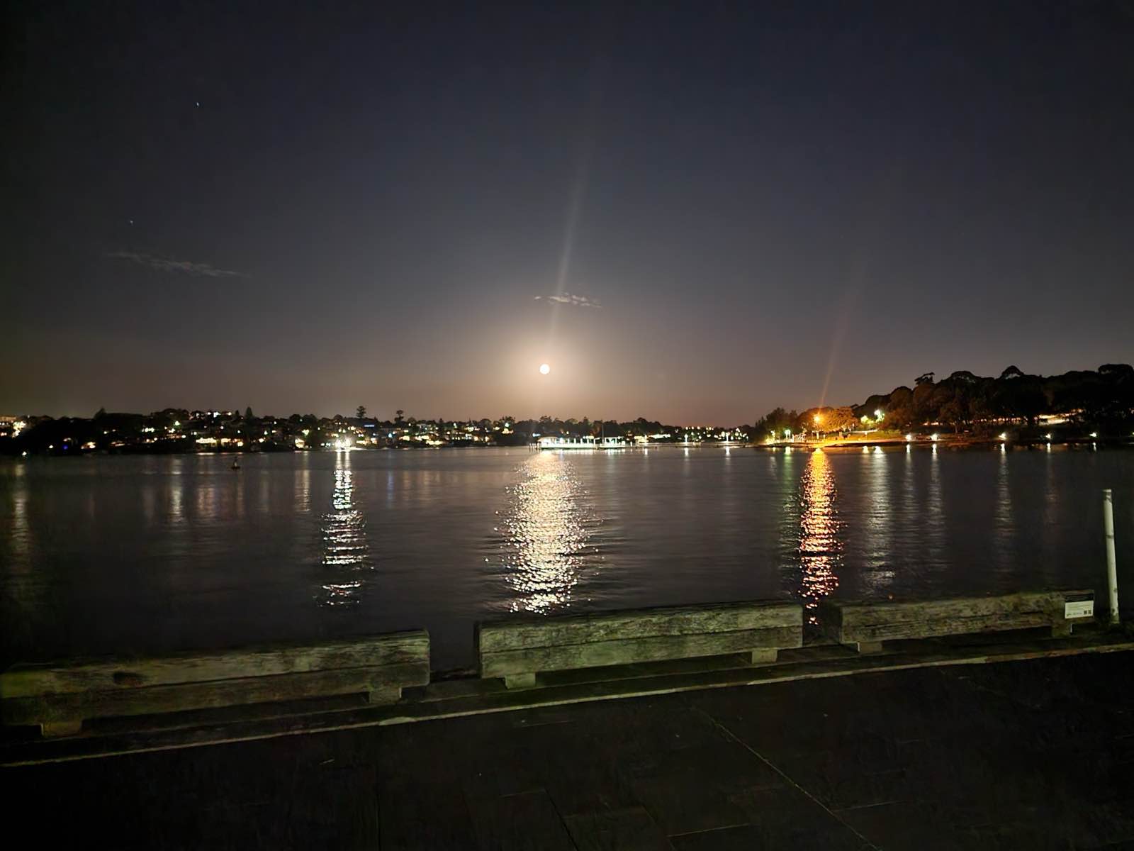 Moonrise over the Parramatta River seen from the foreshore promenade at night