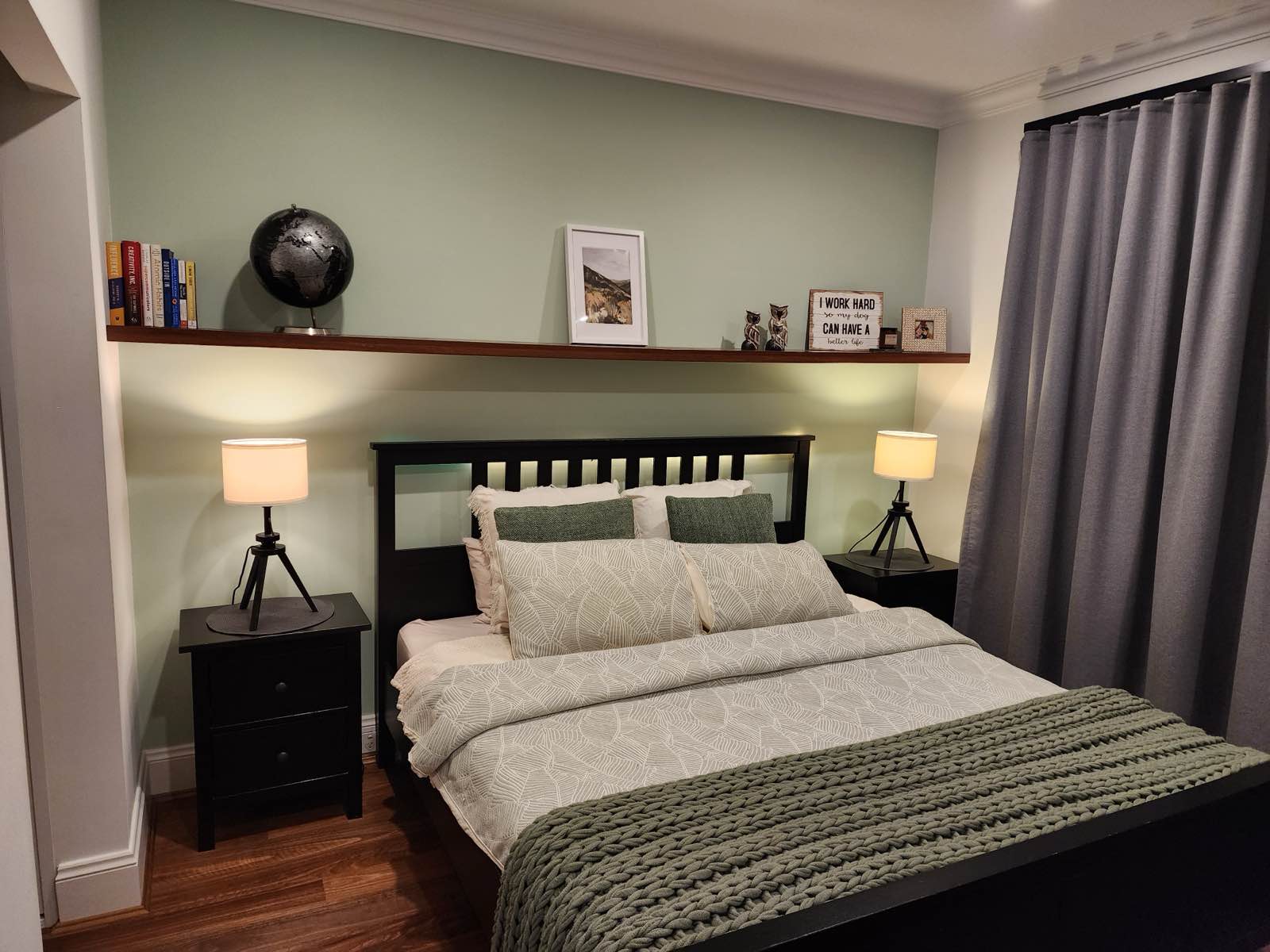 Main bedroom in the evening with the custom timber shelf lit from beneath